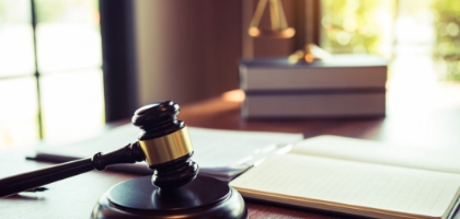Image of a gavel and books on a desk